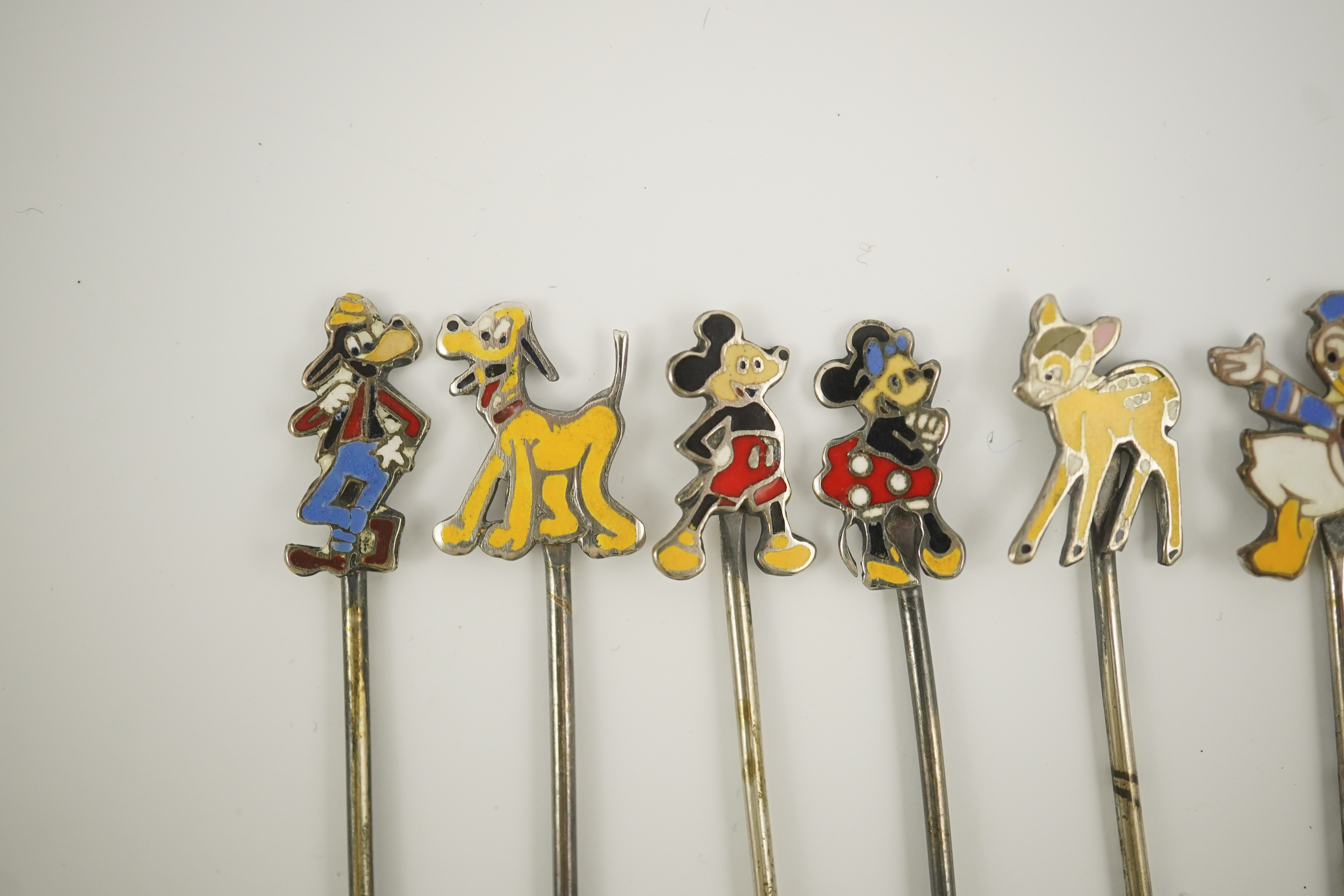 A cased set of six enamelled sterling Disney Character cocktail sticks